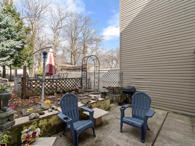 view of patio / terrace featuring fence