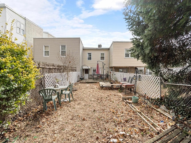 back of property with a fenced backyard