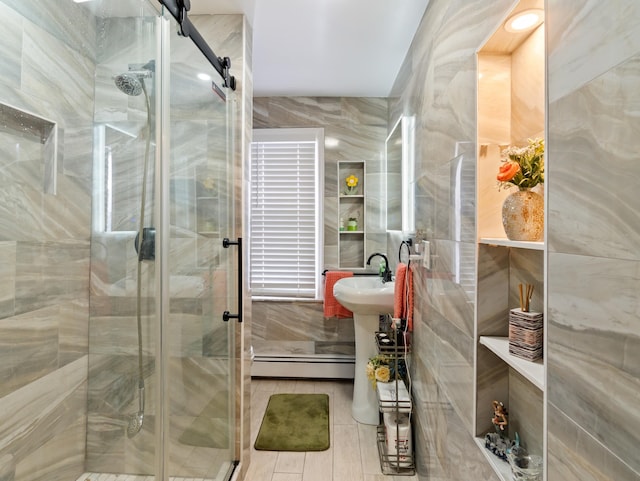 bathroom with a stall shower, tile walls, and a baseboard radiator