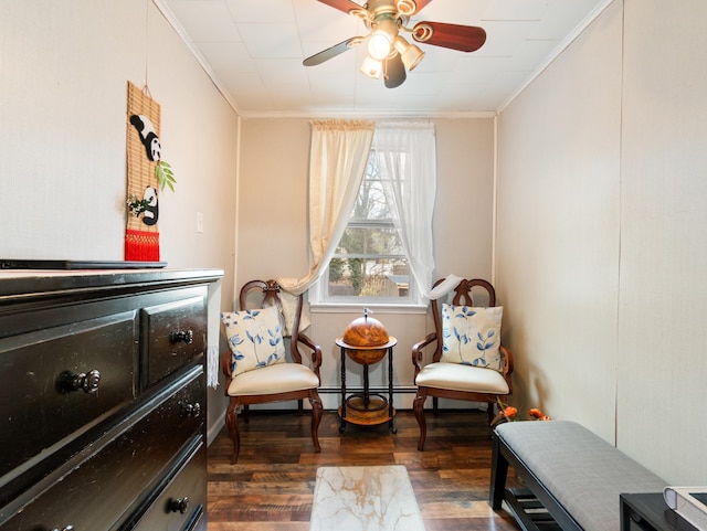 sitting room featuring a baseboard radiator, wood finished floors, a ceiling fan, and ornamental molding