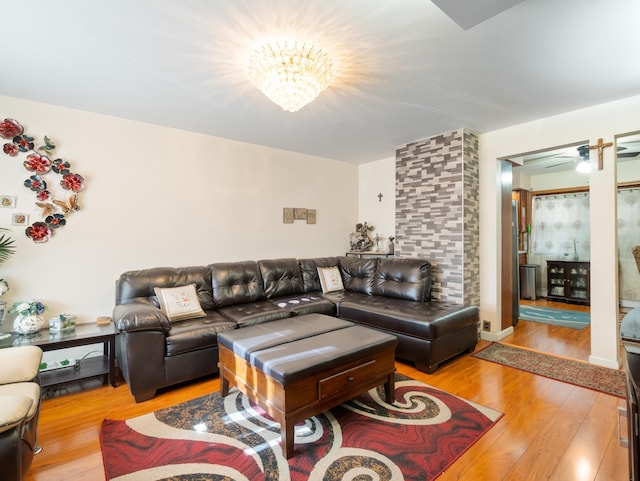 living room with a notable chandelier and light wood-type flooring