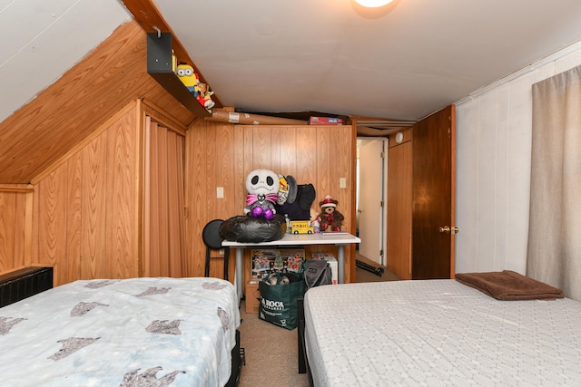 carpeted bedroom featuring vaulted ceiling and wood walls