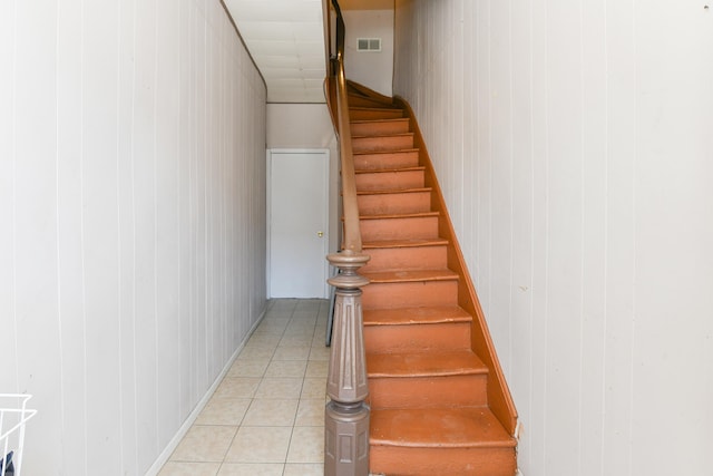 stairway with tile patterned flooring and visible vents