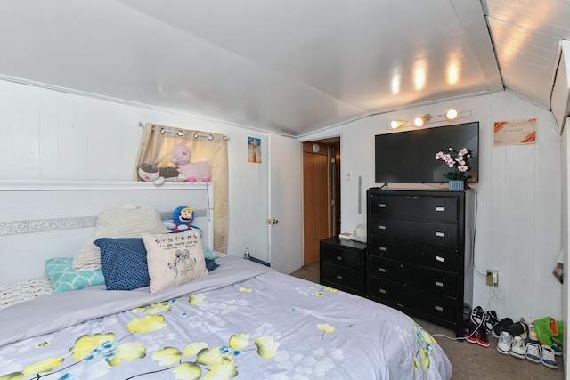 carpeted bedroom with lofted ceiling