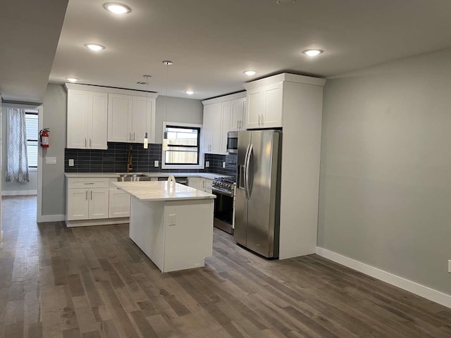 41 Beacon Ave Unit 1, Jersey City, NJ 07306 - kitchen featuring appliances with stainless steel finishes, baseboards, decorative backsplash, white cabinetry, and recessed lighting