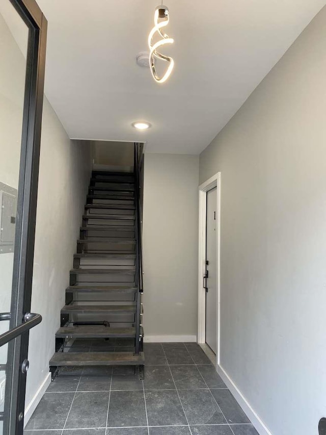 41 Beacon Ave Unit 1, Jersey City, NJ 07306 - stairway with baseboards, tile patterned flooring, and electric panel