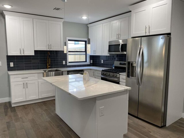 41 Beacon Ave Unit 1, Jersey City, NJ 07306 - kitchen featuring appliances with stainless steel finishes, a sink, dark wood-style flooring, white cabinets, and recessed lighting