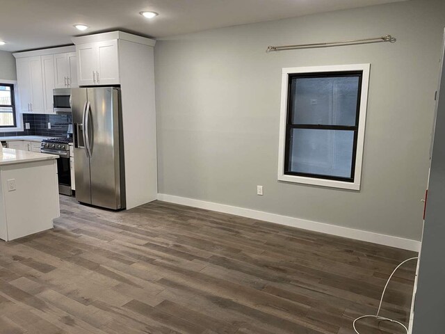 41 Beacon Ave Unit 1, Jersey City, NJ 07306 - kitchen featuring stainless steel appliances, dark wood finished floors, baseboards, white cabinetry, and recessed lighting