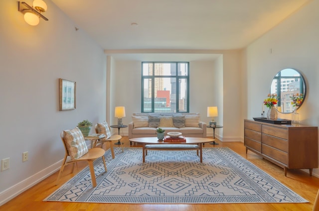 105 Greene St Unit 1101, Jersey City, NJ 07302 - living area featuring baseboards, light wood-style flooring, and a healthy amount of sunlight