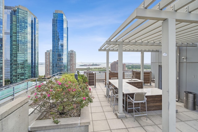 105 Greene St Unit 1101, Jersey City, NJ 07302 - view of patio featuring a view of city, a water view, a sink, and a pergola