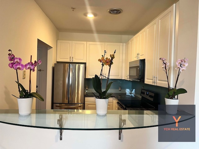 1100 River Rd, Edgewater, NJ 07020 - kitchen featuring stainless steel appliances and white cabinetry