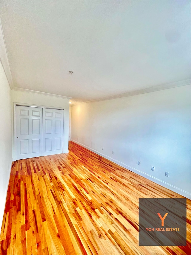 1100 River Rd, Edgewater, NJ 07020 - unfurnished bedroom with a closet, light wood-style floors, and ornamental molding