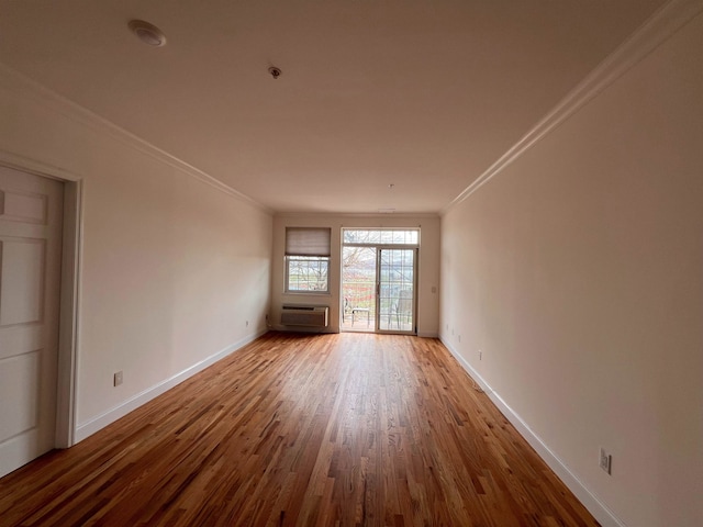 1100 River Rd, Edgewater, NJ 07020 - unfurnished room featuring ornamental molding, baseboards, wood finished floors, and a wall mounted air conditioner