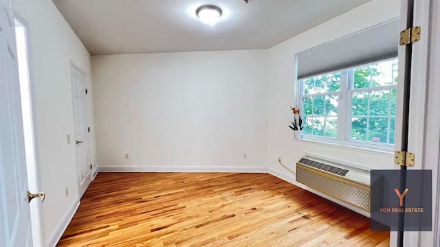 1100 River Rd, Edgewater, NJ 07020 - empty room with light wood finished floors and an AC wall unit