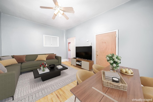 living room featuring ceiling fan and hardwood / wood-style floors