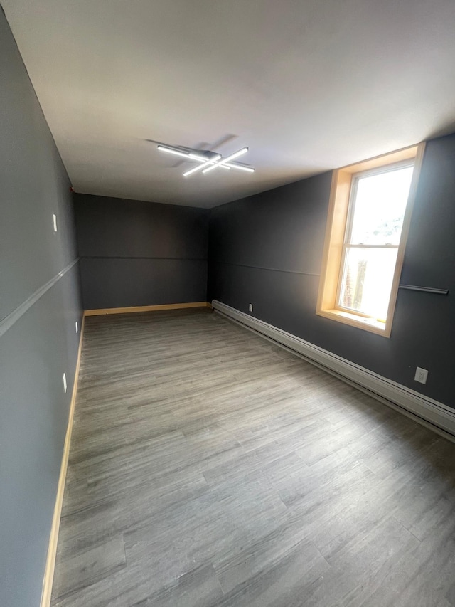 2907 Central Ave, Union City, NJ 07087 - empty room featuring wood finished floors, baseboard heating, and ceiling fan