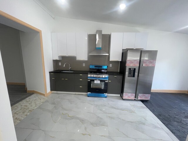 2907 Central Ave, Union City, NJ 07087 - kitchen with wall chimney exhaust hood, appliances with stainless steel finishes, white cabinets, and dark countertops