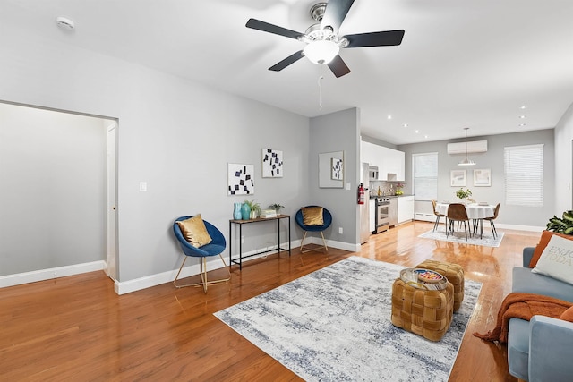 29 51st St Unit A2, Weehawken, NJ 07086 - living room with ceiling fan, an AC wall unit, light wood finished floors, baseboards, and recessed lighting