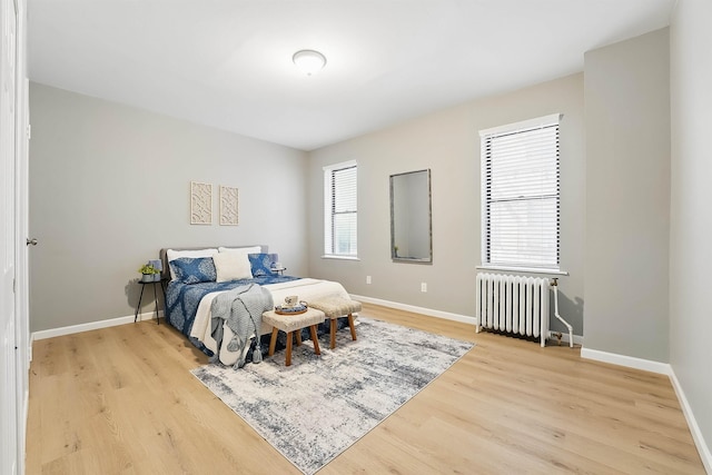 29 51st St Unit A2, Weehawken, NJ 07086 - bedroom with radiator, light wood-style floors, and baseboards