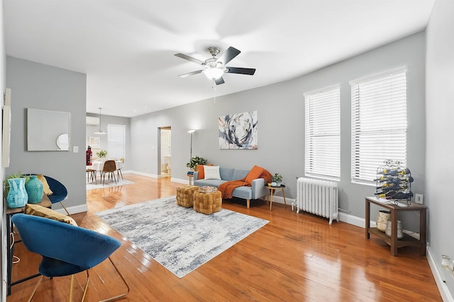 29 51st St Unit A2, Weehawken, NJ 07086 - living room featuring radiator heating unit, ceiling fan, light wood-style floors, and baseboards