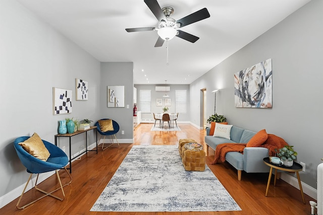 29 51st St Unit A2, Weehawken, NJ 07086 - living area featuring ceiling fan, wood finished floors, baseboards, and a wall mounted AC