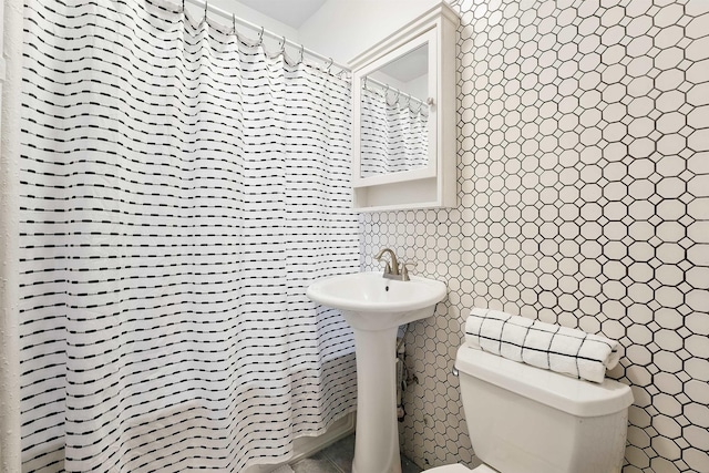 29 51st St Unit A2, Weehawken, NJ 07086 - full bathroom with toilet, tile walls, and a shower with shower curtain