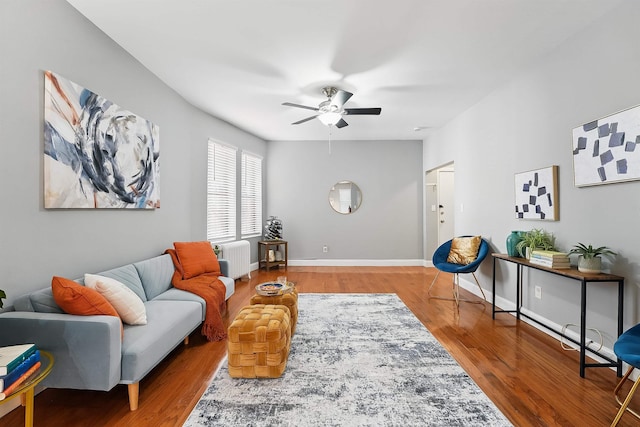 29 51st St Unit A2, Weehawken, NJ 07086 - living area with radiator heating unit, a ceiling fan, wood finished floors, and baseboards