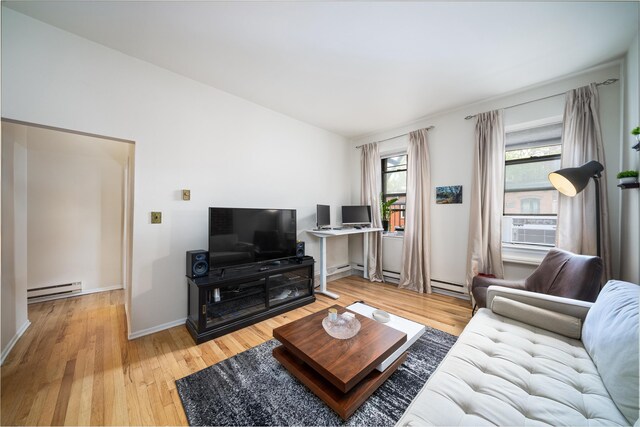 230 Bloomfield St Unit 302, Hoboken, NJ 07030 - living area with a baseboard radiator, wood finished floors, cooling unit, and baseboards
