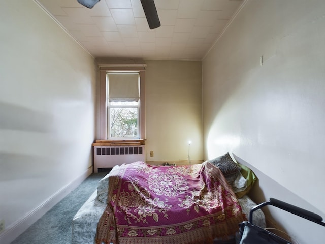 carpeted bedroom with radiator, ornamental molding, and ceiling fan