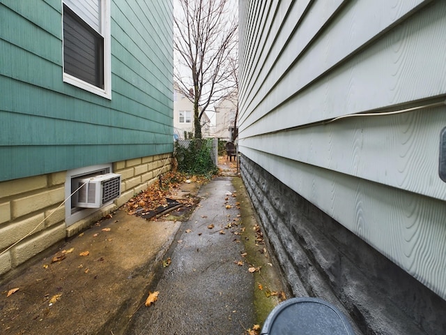 view of home's exterior with a wall mounted AC