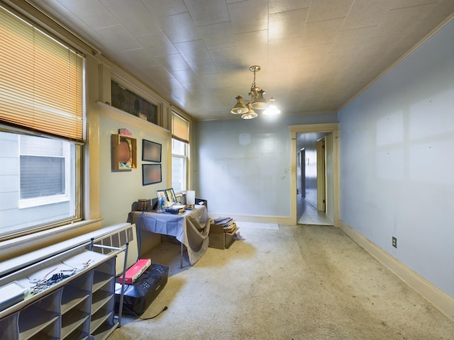 sitting room featuring carpet flooring, a chandelier, and ornamental molding