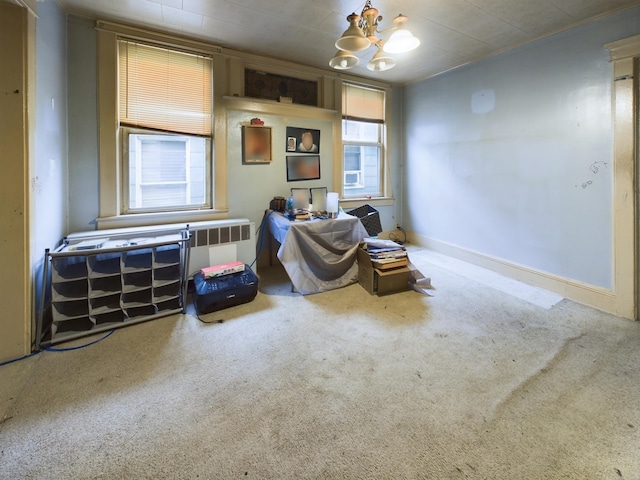 living area with carpet and a chandelier