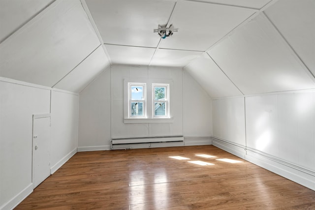 bonus room featuring hardwood / wood-style flooring, baseboard heating, and vaulted ceiling