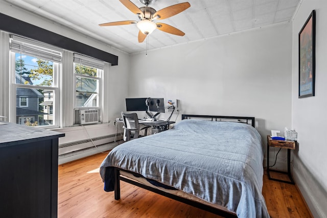 bedroom with ceiling fan, cooling unit, light hardwood / wood-style floors, and a baseboard radiator