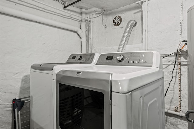 clothes washing area featuring independent washer and dryer