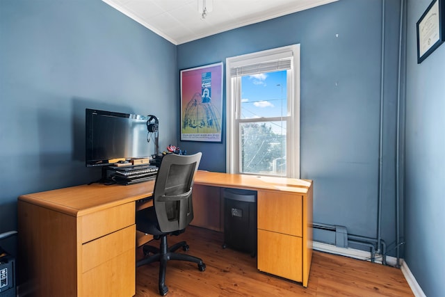 office area featuring baseboard heating, light hardwood / wood-style flooring, and ornamental molding