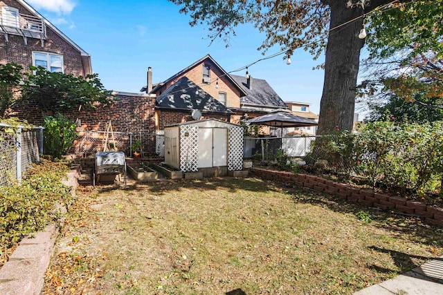 view of yard featuring a storage unit and a gazebo