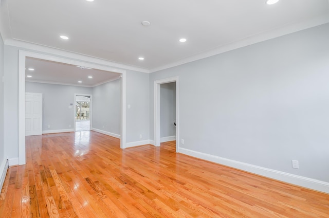 unfurnished room with light wood finished floors, baseboards, crown molding, and recessed lighting