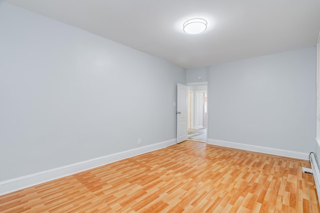 empty room featuring light wood-style flooring and baseboards