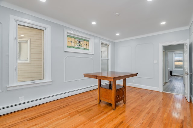 dining room featuring recessed lighting, light wood-style flooring, a baseboard heating unit, ornamental molding, and baseboards