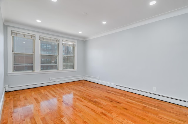 unfurnished room featuring ornamental molding, a baseboard radiator, wood finished floors, and recessed lighting