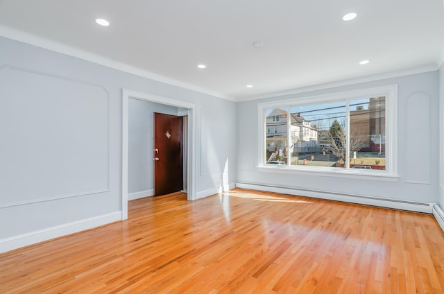 spare room featuring light wood-style flooring, baseboards, baseboard heating, and recessed lighting