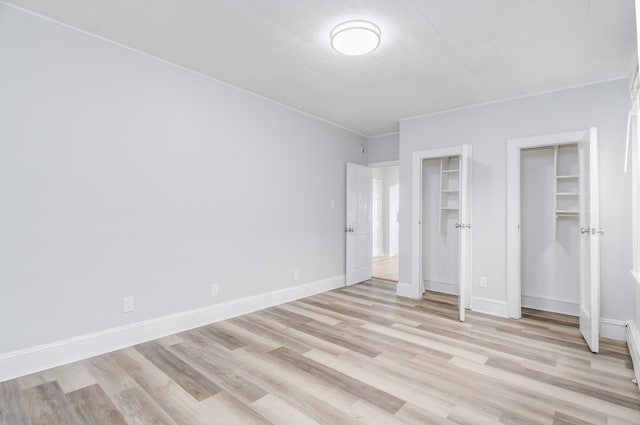 unfurnished bedroom with light wood finished floors and baseboards