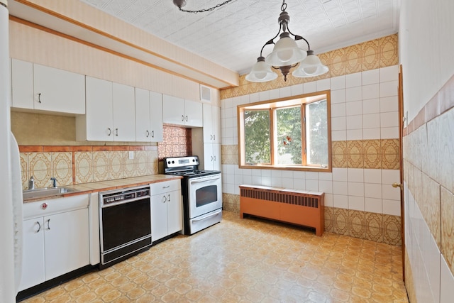 71 W 17th St, Bayonne, NJ 07002 - kitchen featuring stainless steel electric stove, black dishwasher, radiator, light countertops, and white cabinetry