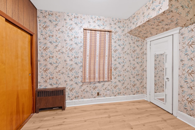 71 W 17th St, Bayonne, NJ 07002 - spare room with radiator, light wood-type flooring, and wallpapered walls