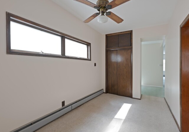 71 W 17th St, Bayonne, NJ 07002 - unfurnished bedroom with a baseboard heating unit, a closet, light carpet, and a ceiling fan