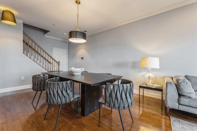 dining area featuring ornamental molding and dark hardwood / wood-style flooring