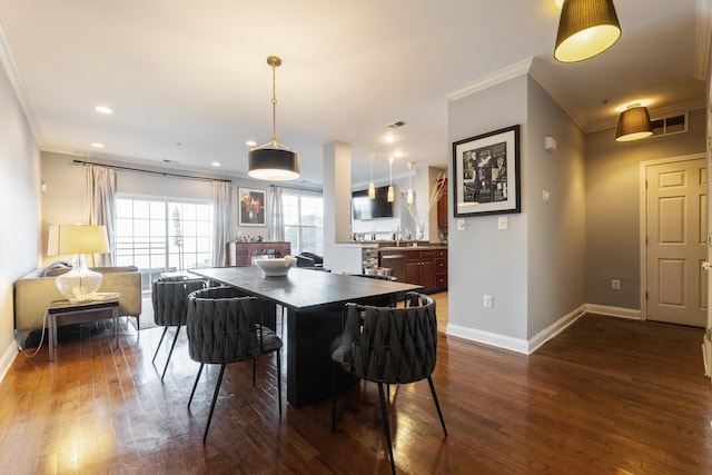 dining area with dark hardwood / wood-style flooring and ornamental molding