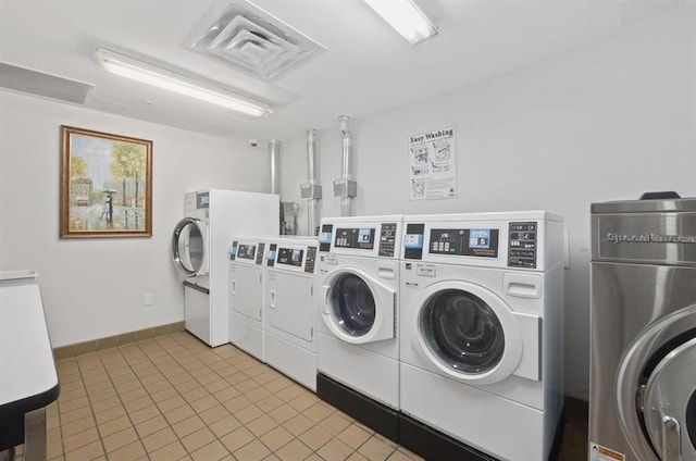 1201 Summit Ave Unit 402, Jersey City, NJ 07307 - community laundry featuring washing machine and clothes dryer and light tile patterned floors