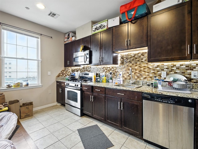 1201 Summit Ave Unit 402, Jersey City, NJ 07307 - kitchen featuring appliances with stainless steel finishes, decorative backsplash, and light tile patterned floors